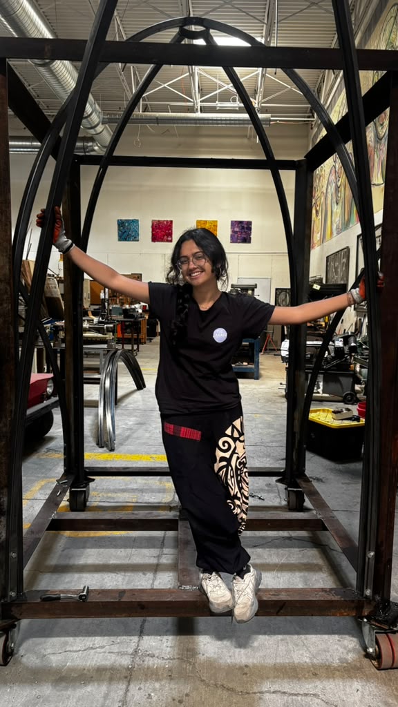 Varsha inside the metal frame structure