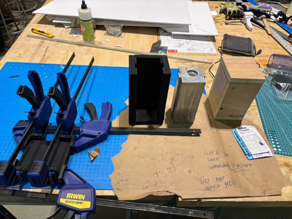 Fabrication in progress — clamps, black stained casing